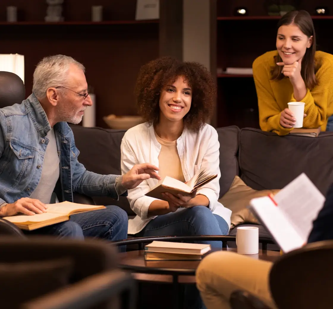 Group of four people reading books together